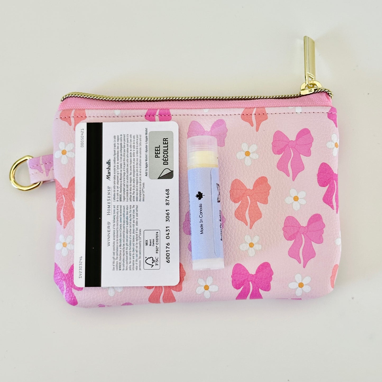 Pink coquette bow vegan leather coin purse with butterfly pattern on a white background