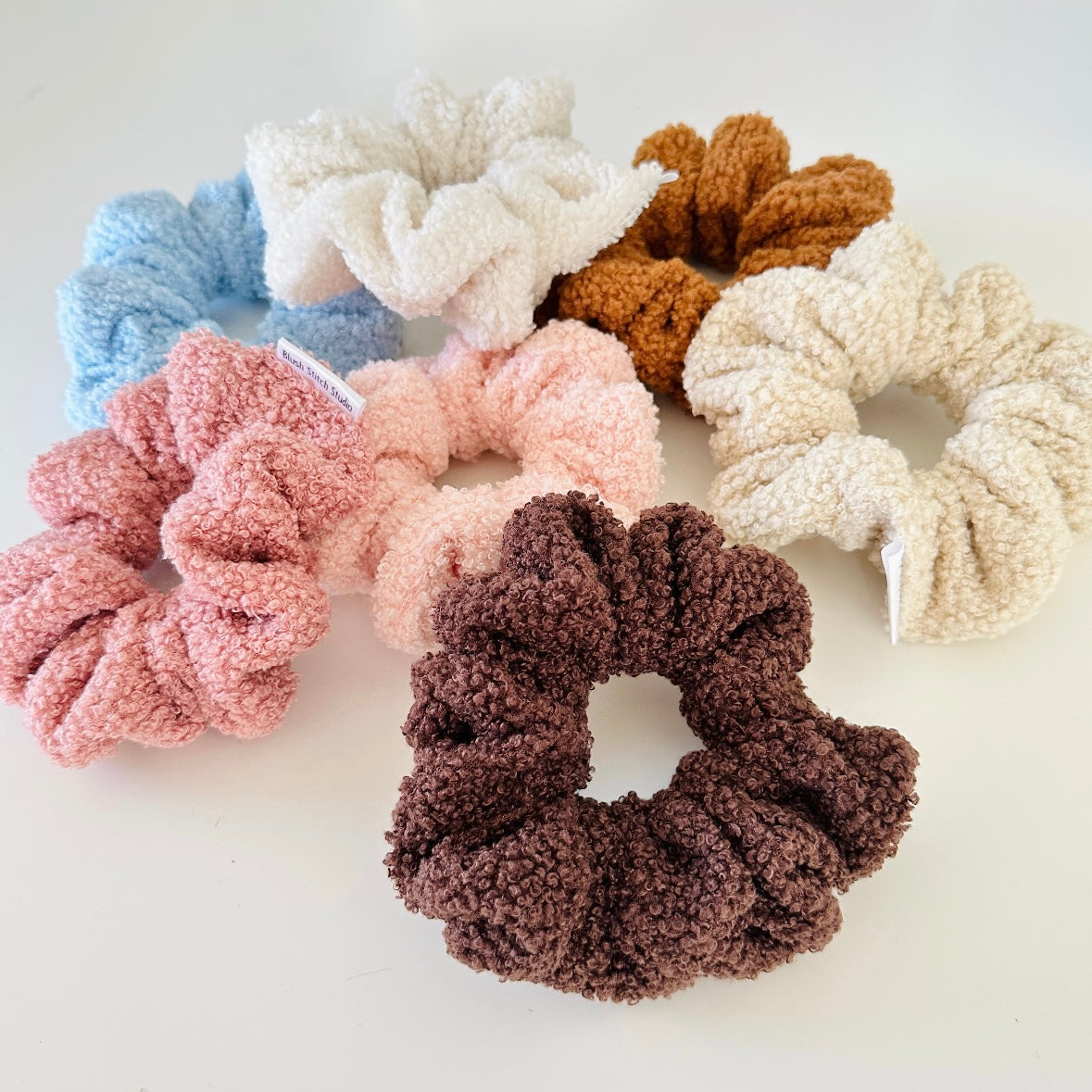 Set of colorful sherpa scrunchies on a light background