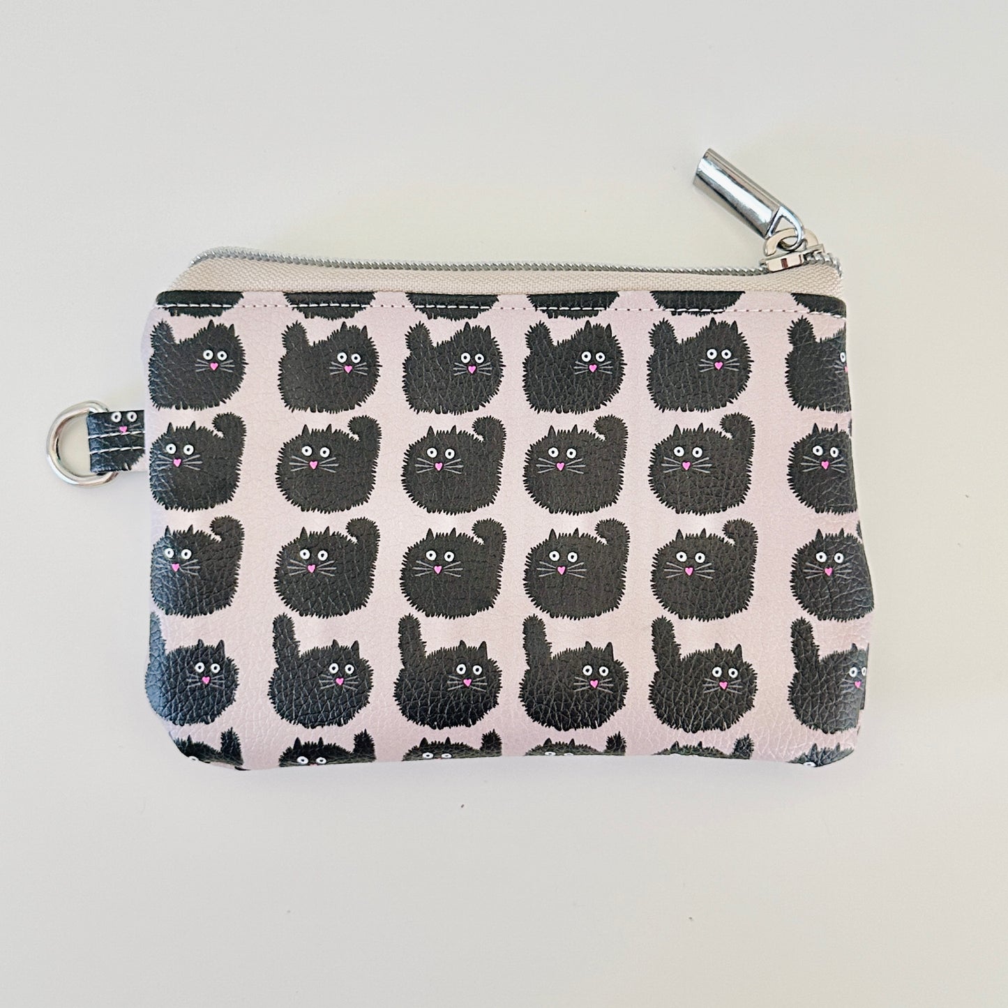 coin purse with a black cat pattern on a light background