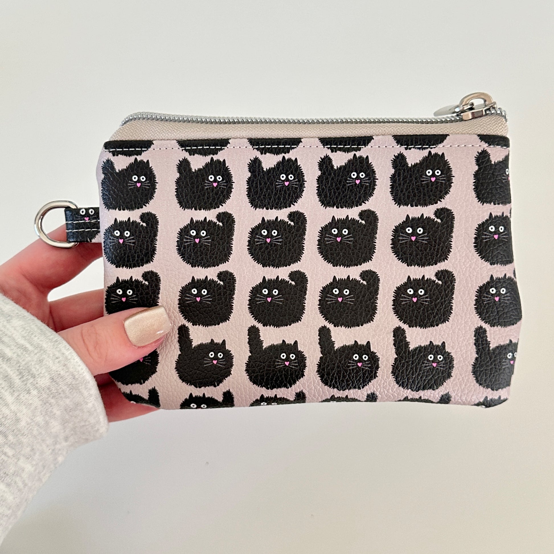 coin purse with a black cat pattern on a light background