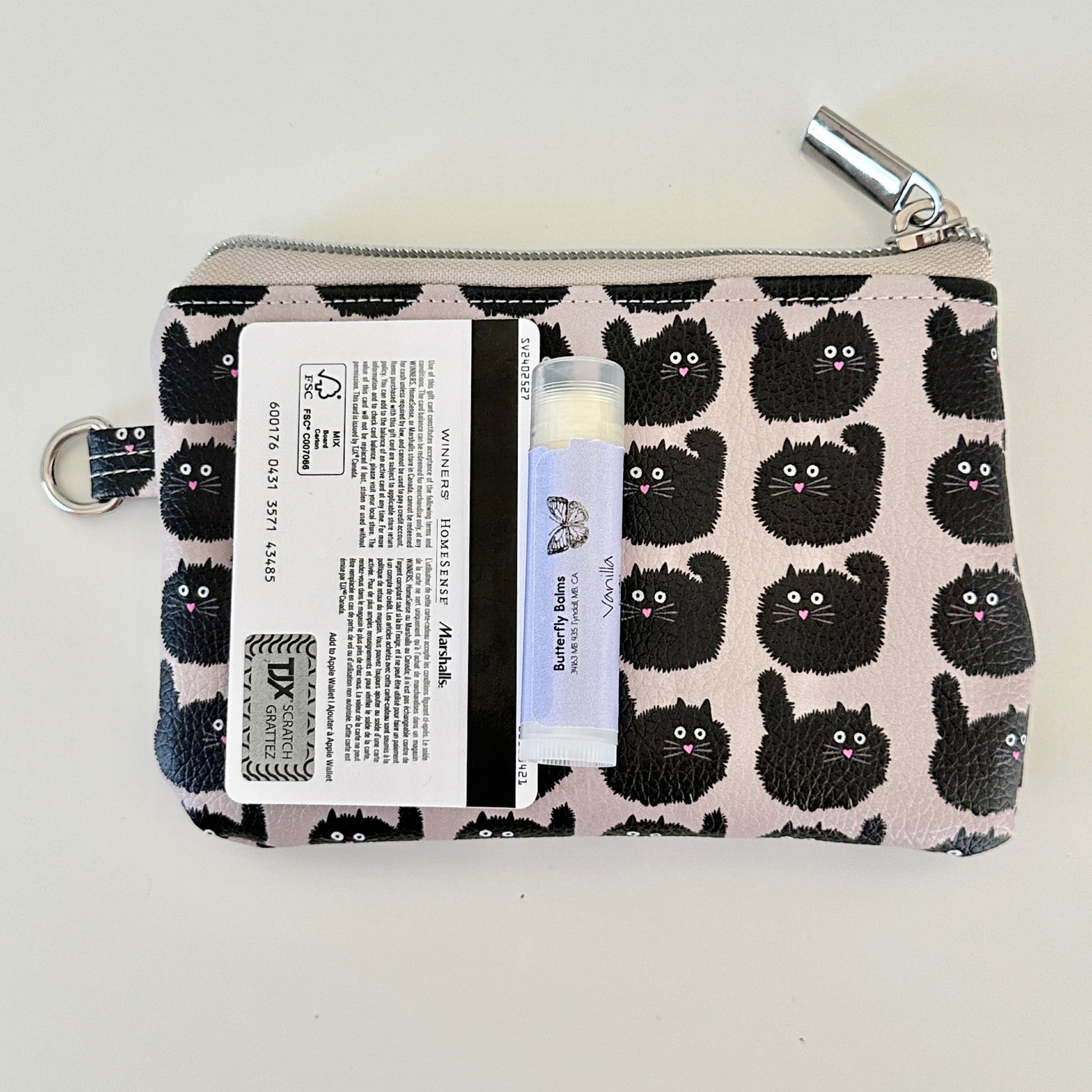 coin purse with a black cat pattern on a light background