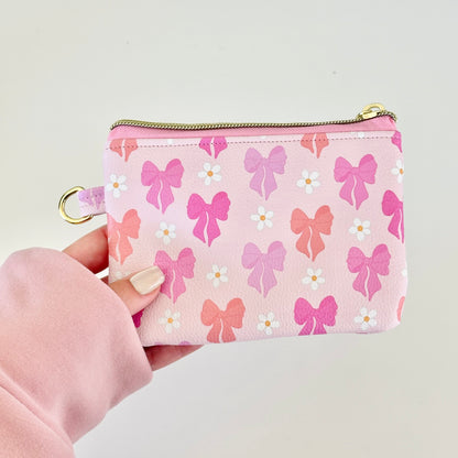 Pink coquette bow vegan leather coin purse with butterfly pattern on a white background