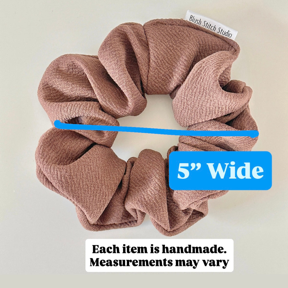 Brown scrunchie with a blue measurement label indicating 5 inches wide on a light background.