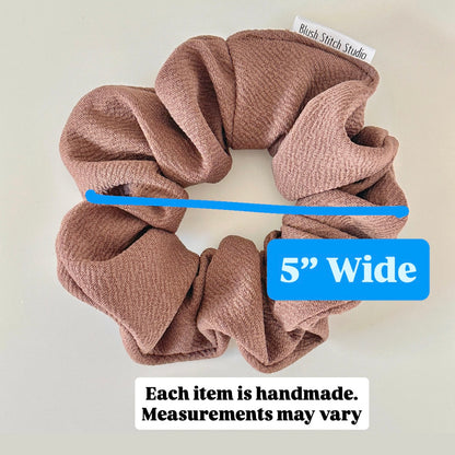 Brown scrunchie with a blue measurement label indicating 5 inches wide on a light background.