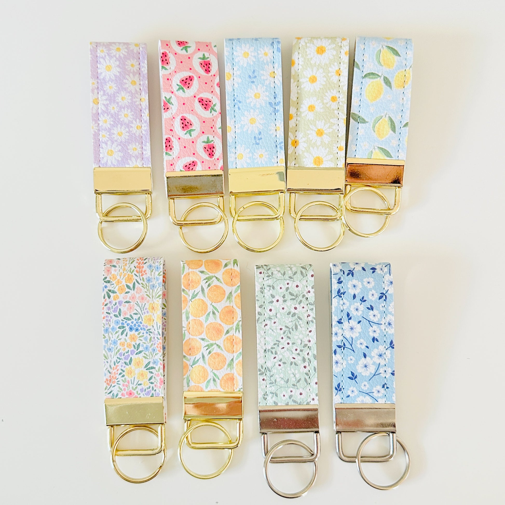 Set of colorful keychains with floral patterns on a white background