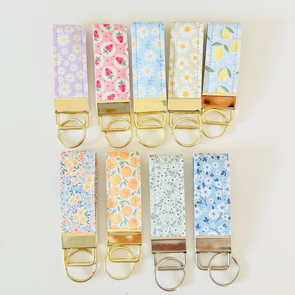 Set of colorful keychains with floral patterns on a white background