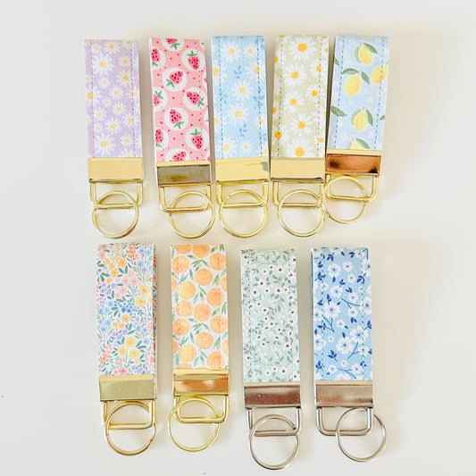 Set of colorful keychains with floral patterns on a white background