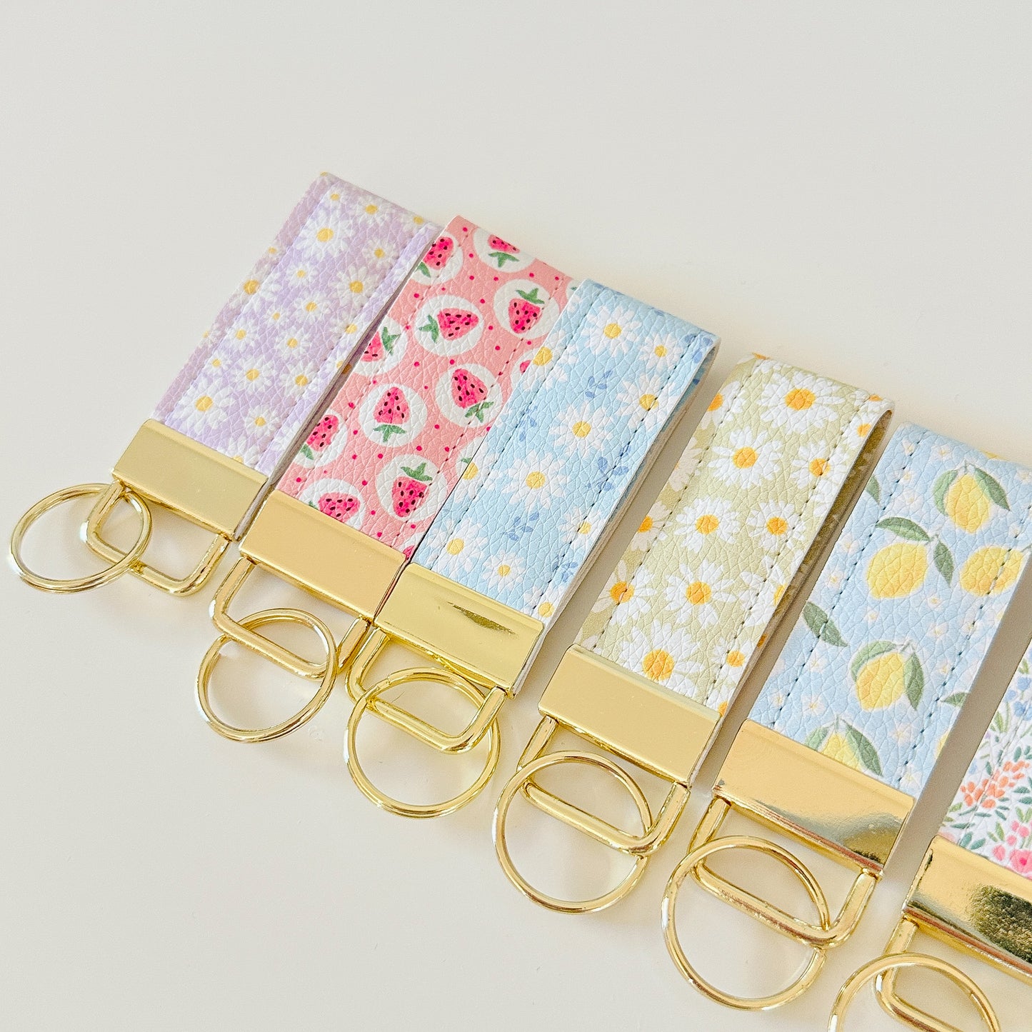 daisy floral and strawberry keychains with gold hardware