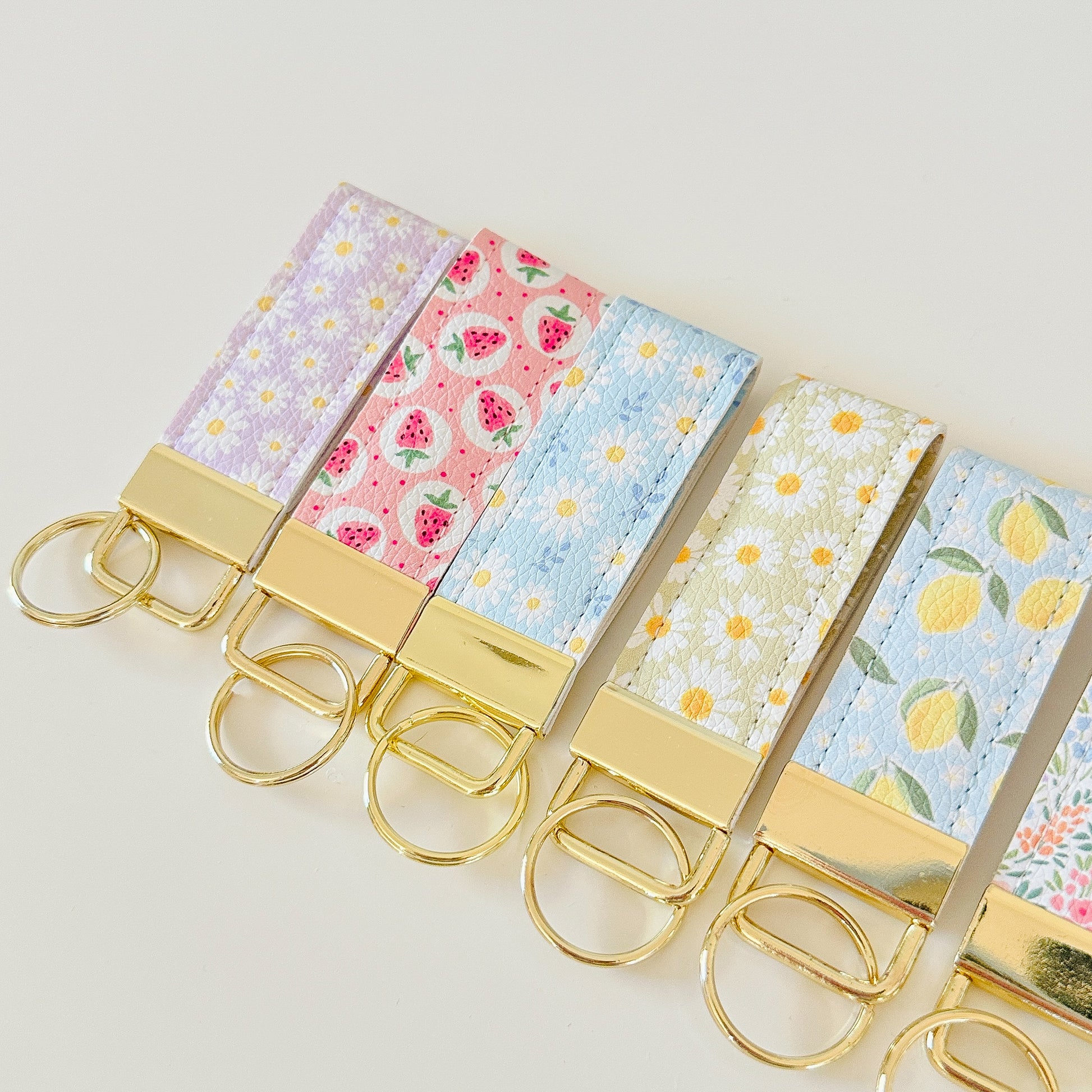 daisy floral and strawberry keychains with gold hardware