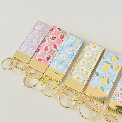 daisy floral and strawberry keychains with gold hardware