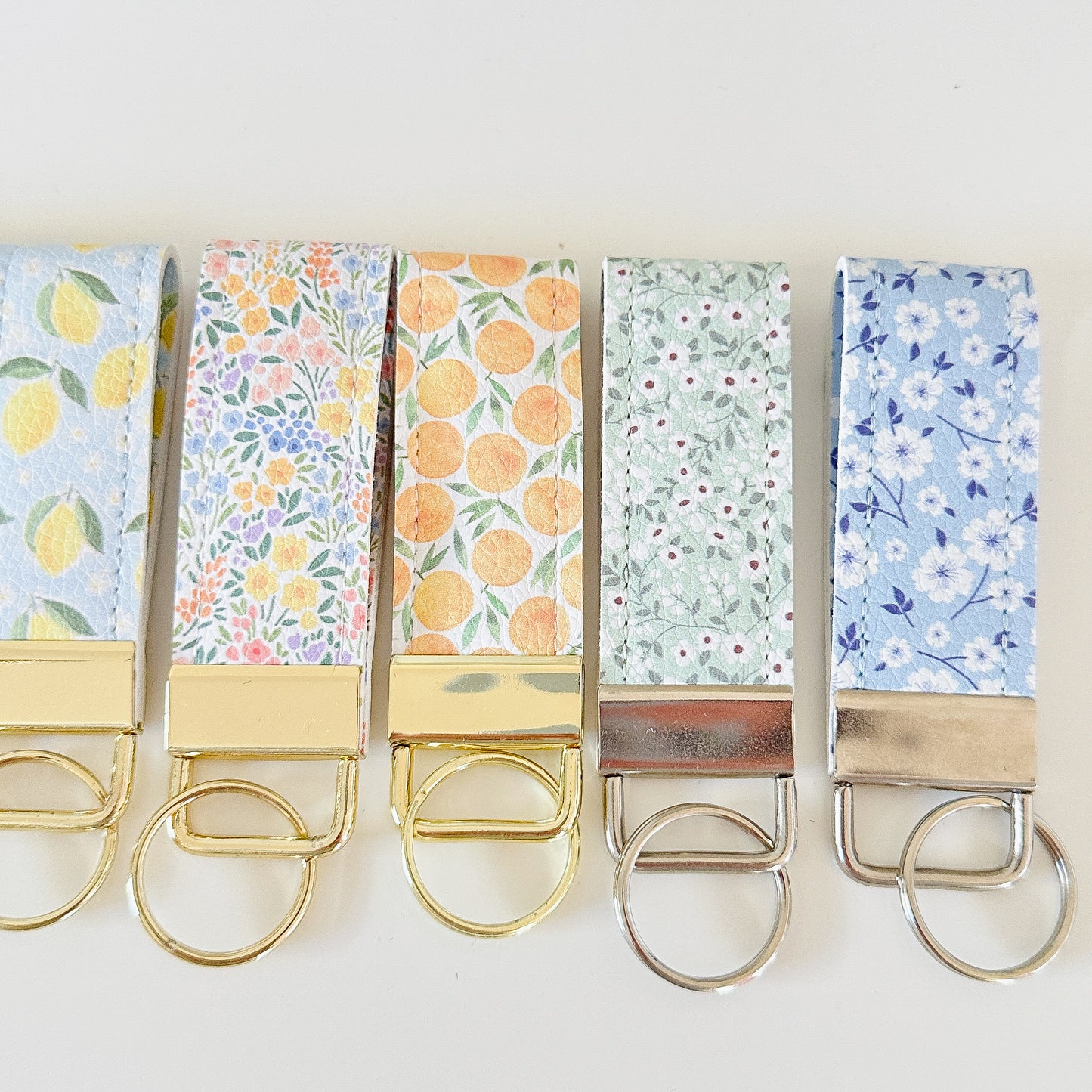 daisy floral and strawberry keychains with gold hardware