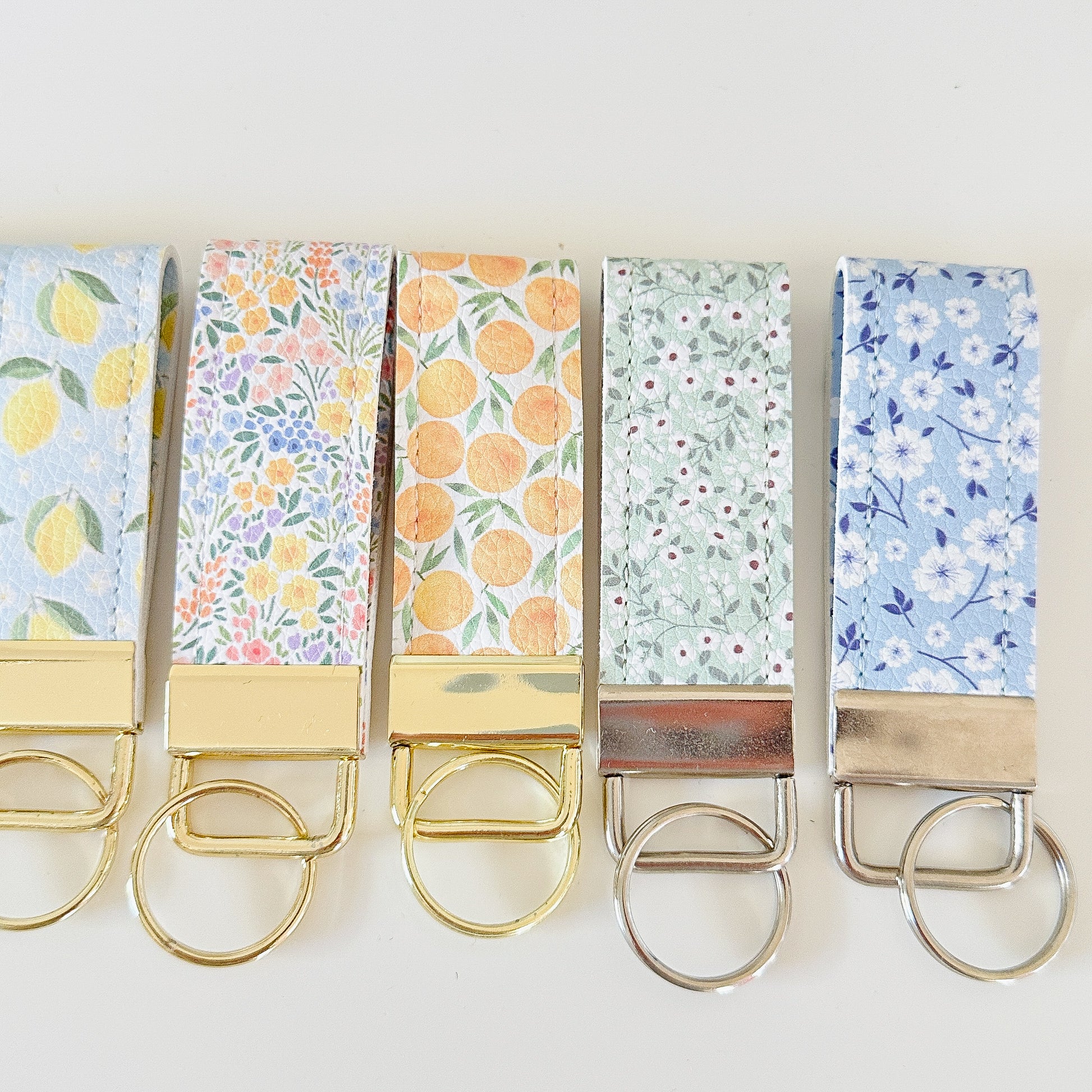 daisy floral and strawberry keychains with gold hardware