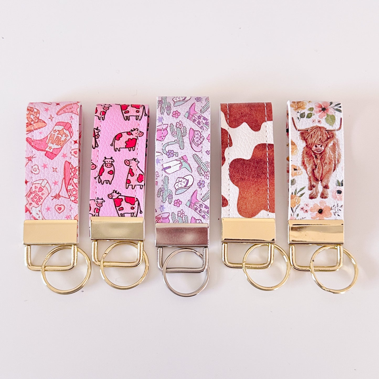 Western highland cow print and cowgirl pattern keychains made from vegan leather 