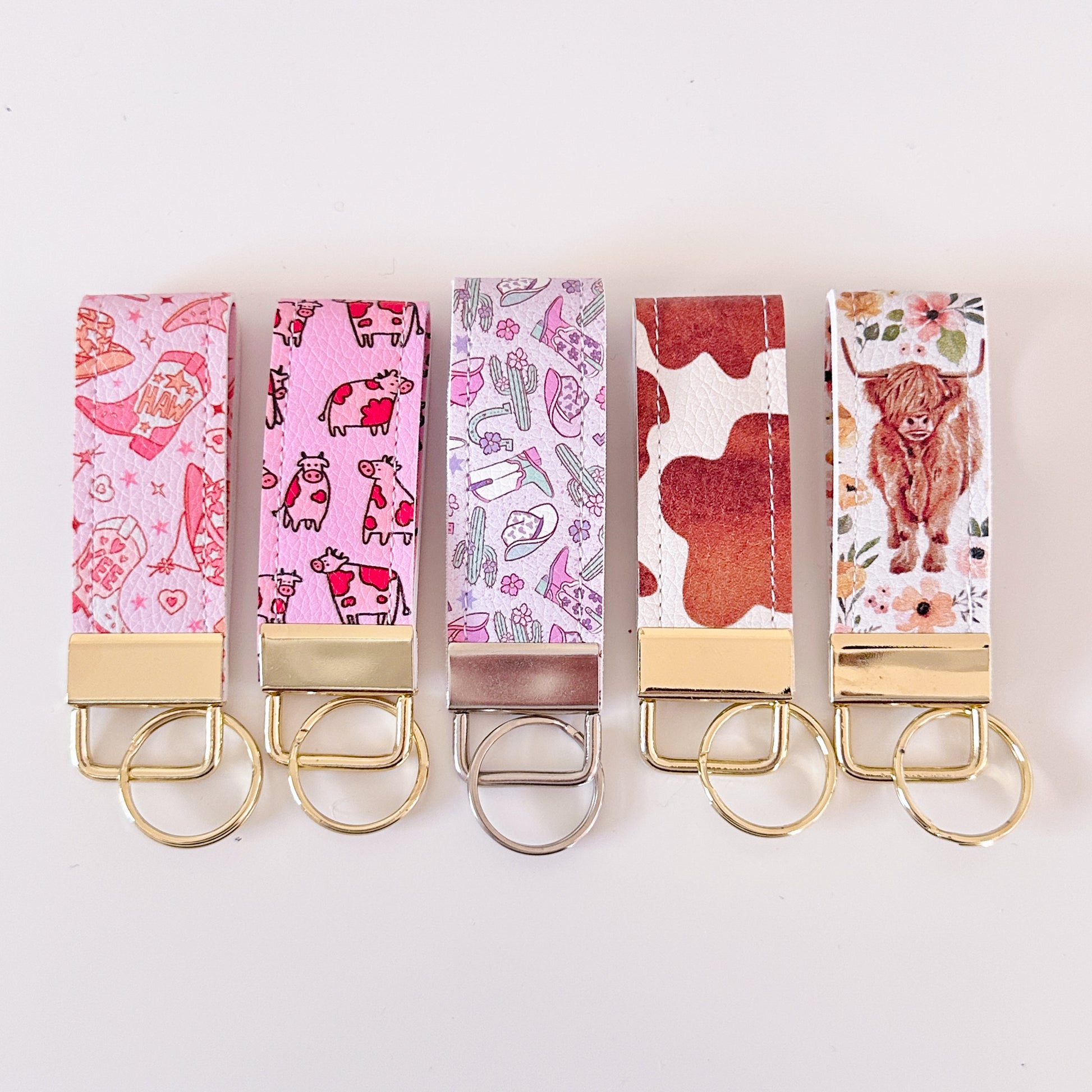 Western highland cow print and cowgirl pattern keychains made from vegan leather 