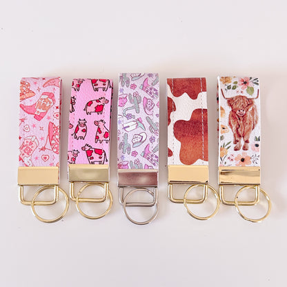 Western highland cow print and cowgirl pattern keychains made from vegan leather 