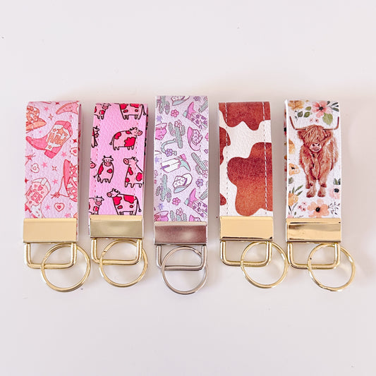 Western highland cow print and cowgirl pattern keychains made from vegan leather 