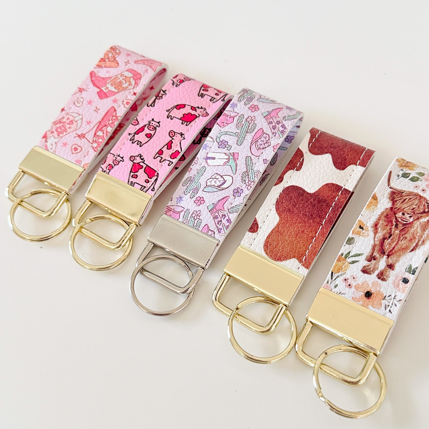 Western highland cow print and cowgirl pattern keychains made from vegan leather 