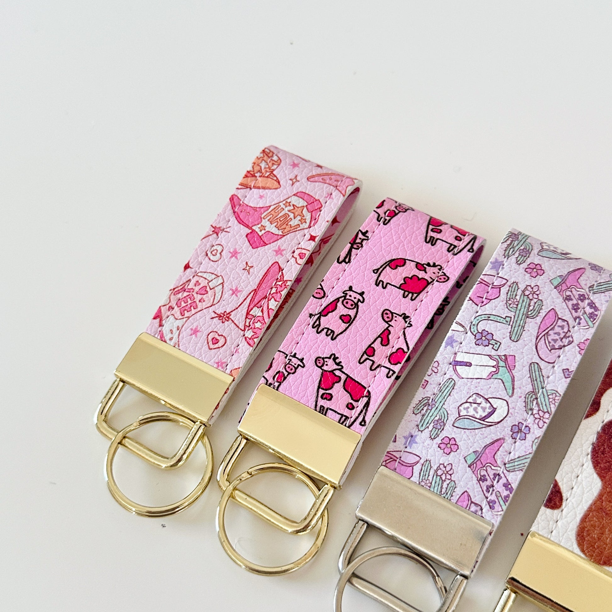 Western highland cow print and cowgirl pattern keychains made from vegan leather 