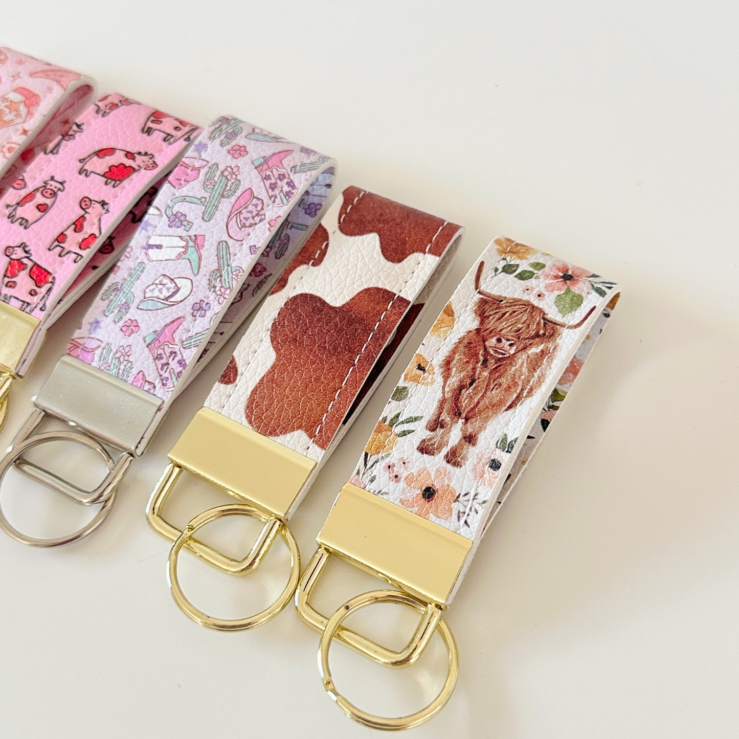 Western highland cow print and cowgirl pattern keychains made from vegan leather 