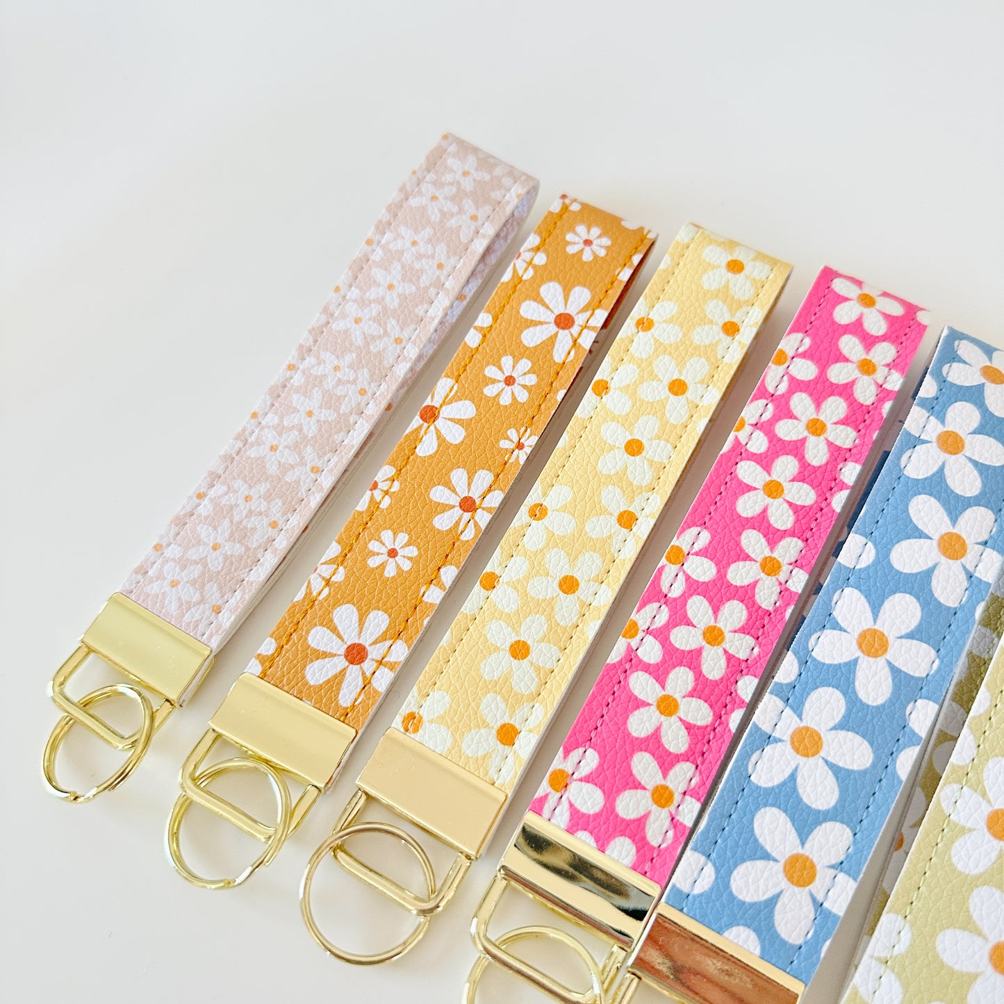 floral daisy vegan leather key wristlets, blue green yellow and pink