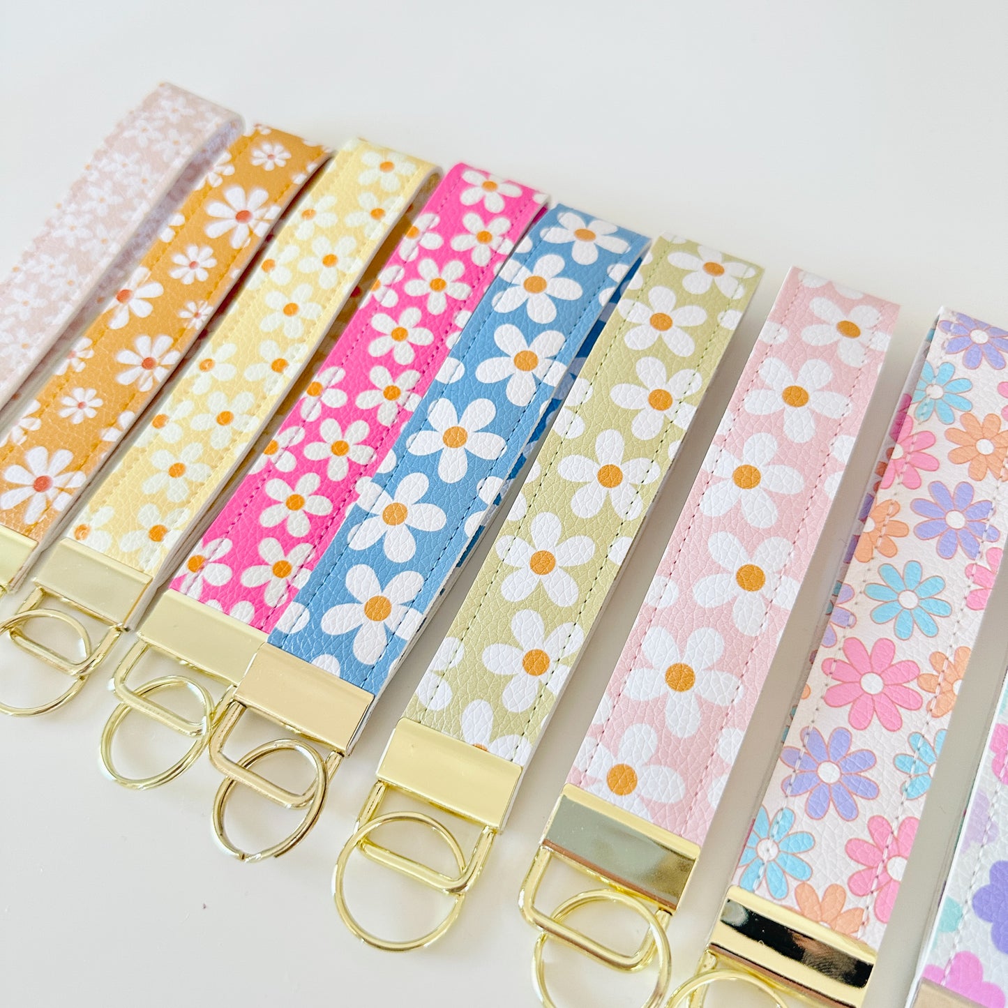 floral daisy vegan leather key wristlets, blue green yellow and pink