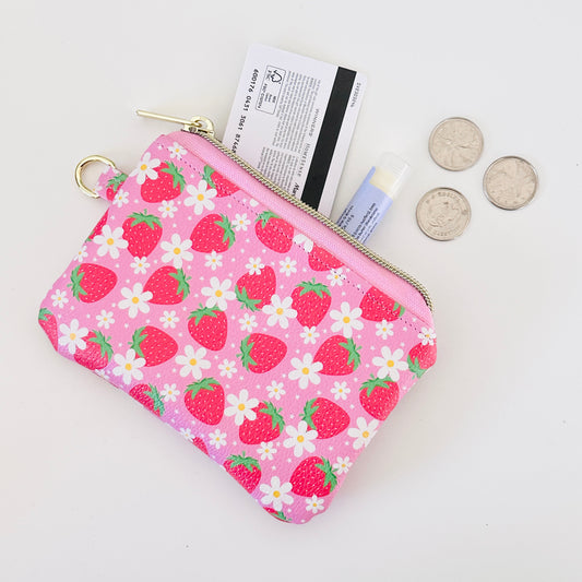 Pink strawberry coin purse  with a daisy pattern on a white background