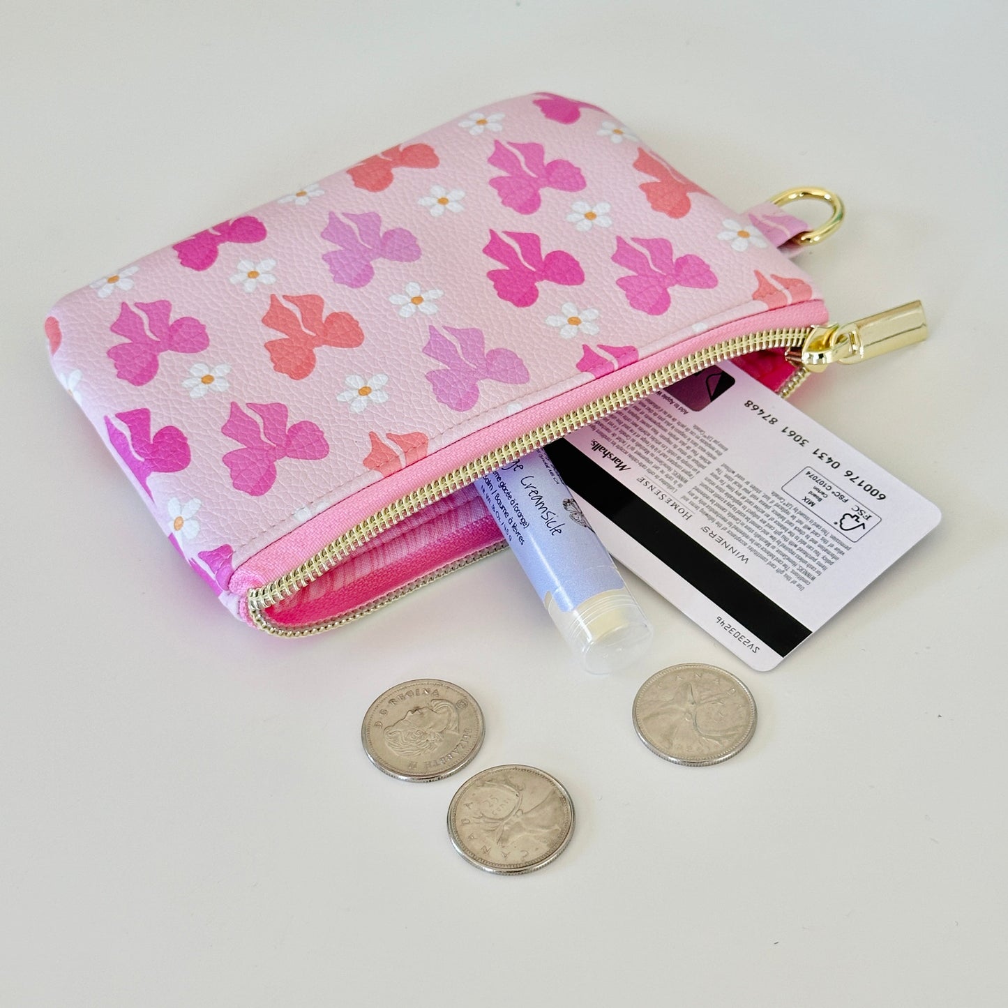 Pink coquette bow vegan leather coin purse with butterfly pattern on a white background