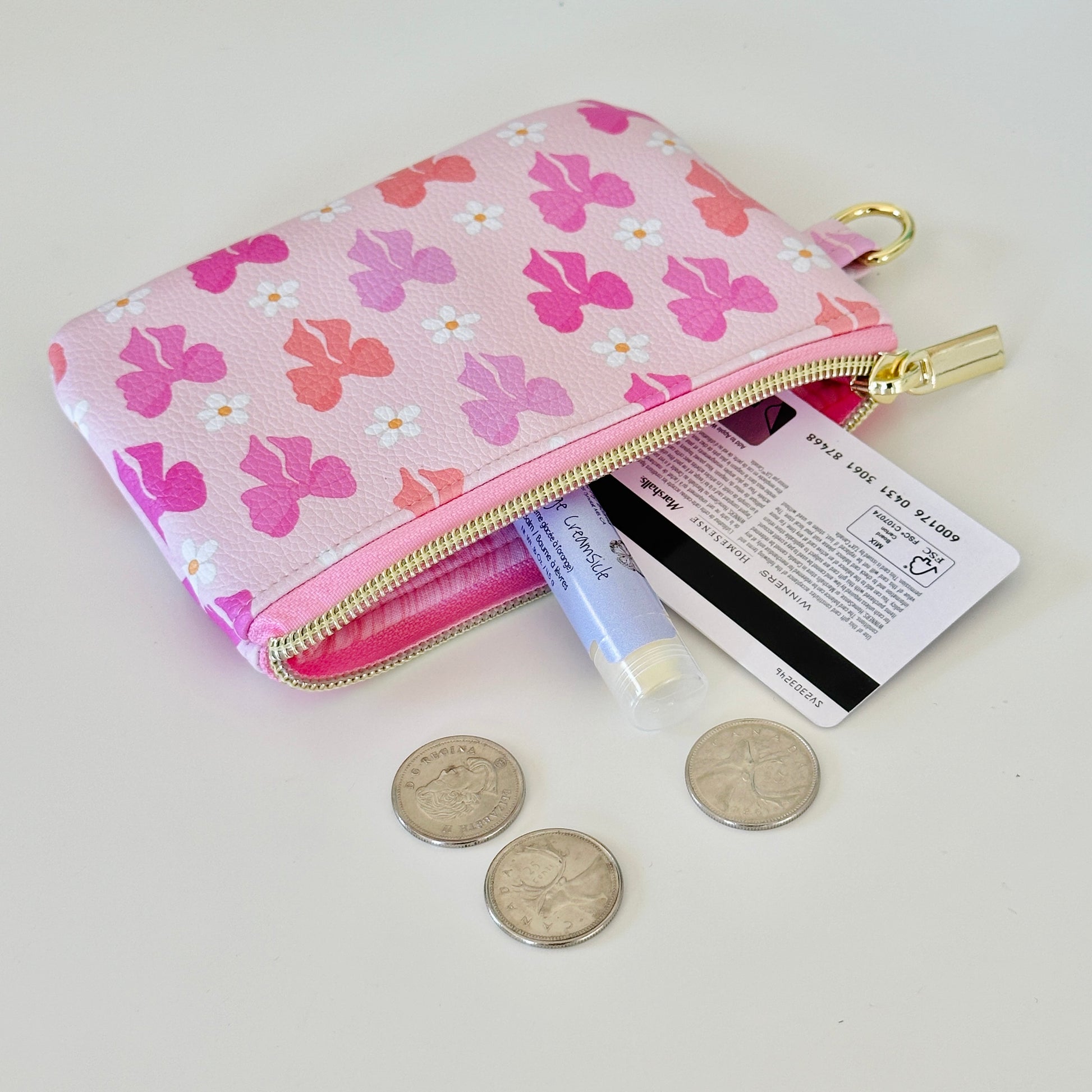 Pink coquette bow vegan leather coin purse with butterfly pattern on a white background
