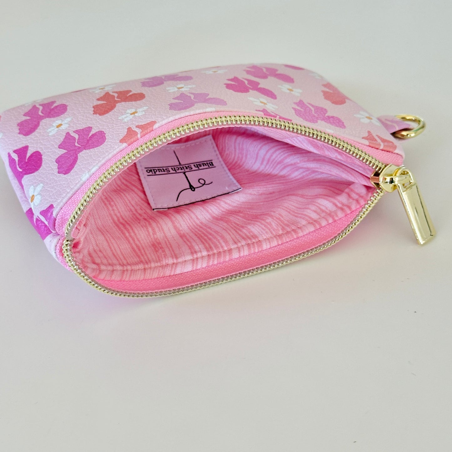 Pink coquette bow vegan leather coin purse with butterfly pattern on a white background