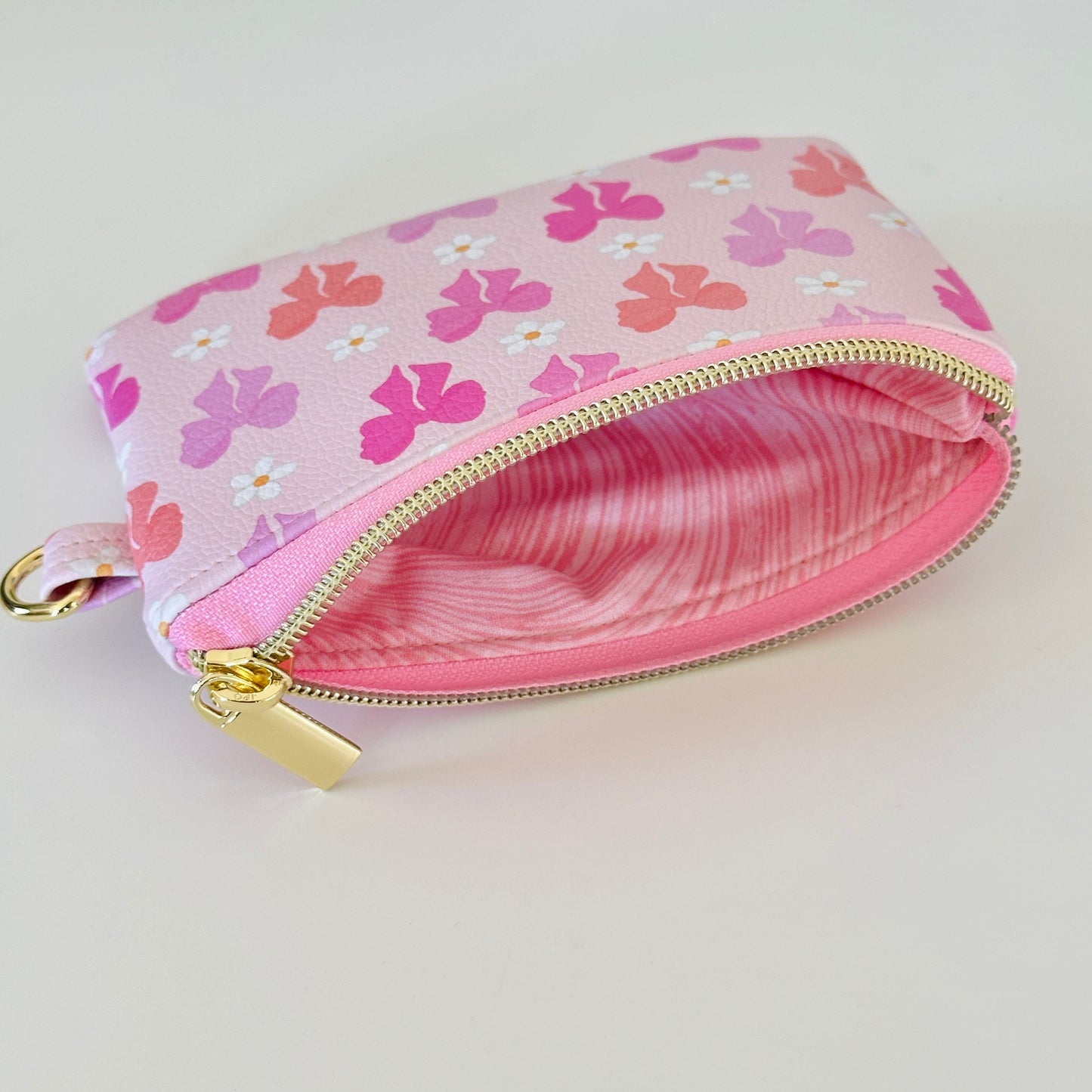 Pink coquette bow vegan leather coin purse with butterfly pattern on a white background