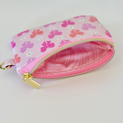 Pink coquette bow vegan leather coin purse with butterfly pattern on a white background