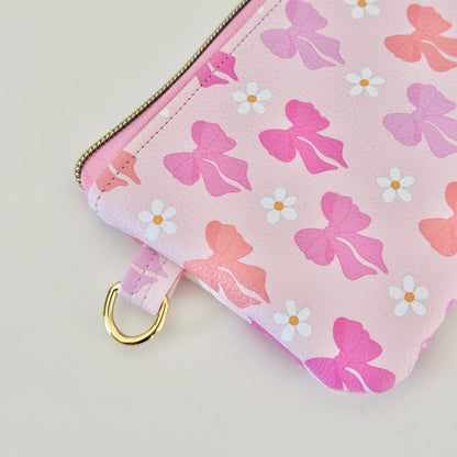 Pink coquette bow vegan leather coin purse with butterfly pattern on a white background