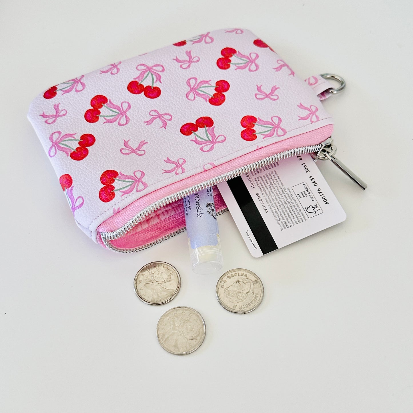 vegan leather coin purse with cherry bow pattern on a white background