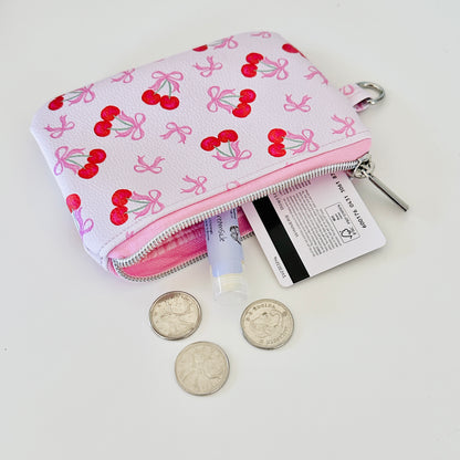 vegan leather coin purse with cherry bow pattern on a white background