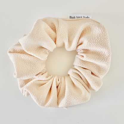 ivory scrunchie on a light gray background with 'Blush Stitch Studio' branding.