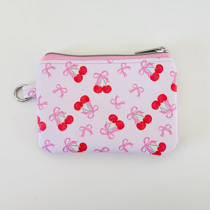 vegan leather coin purse with cherry bow pattern on a white background