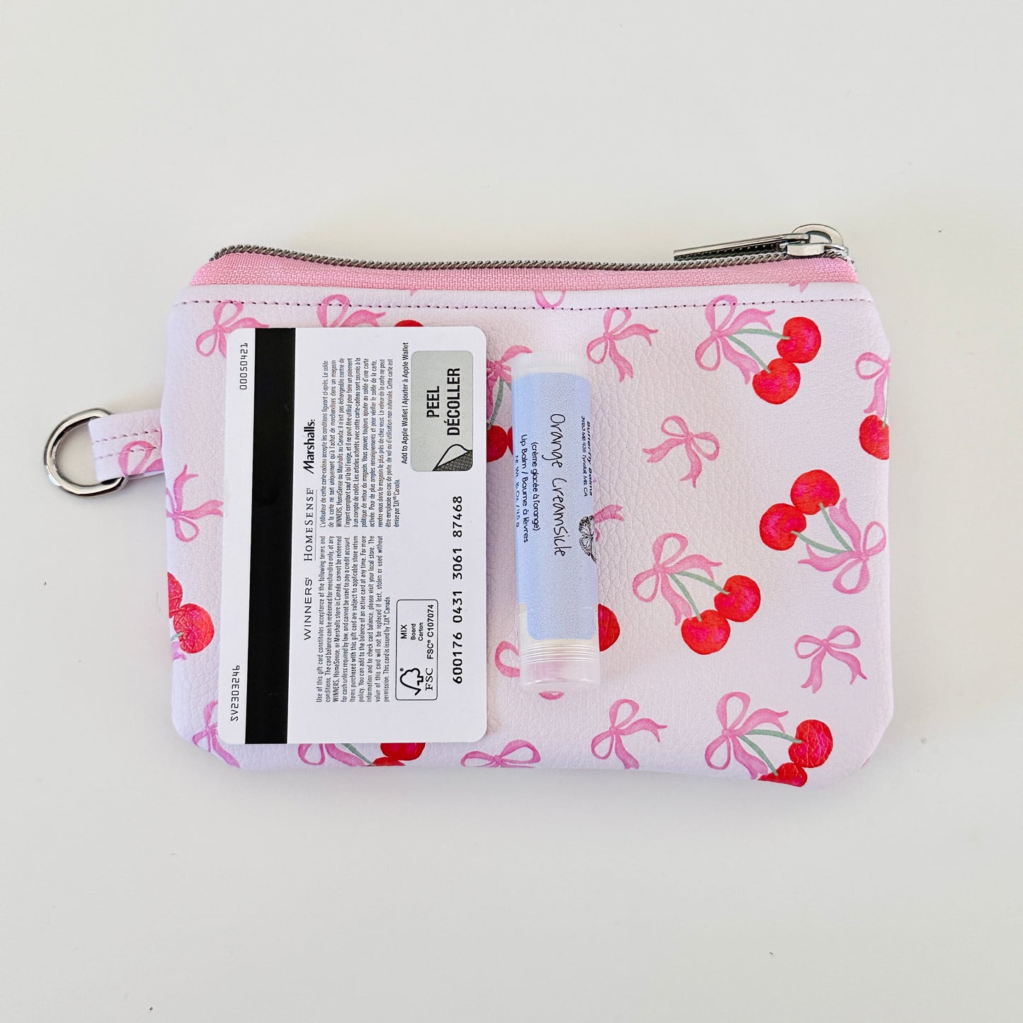 vegan leather coin purse with cherry bow pattern on a white background