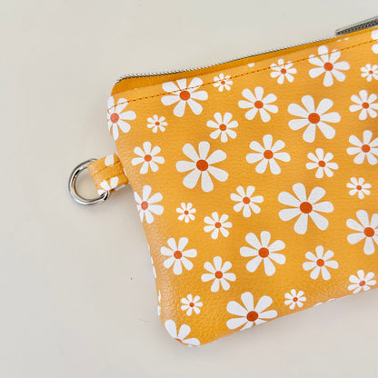 mustard Yellow coin purse with white floral pattern on a white background