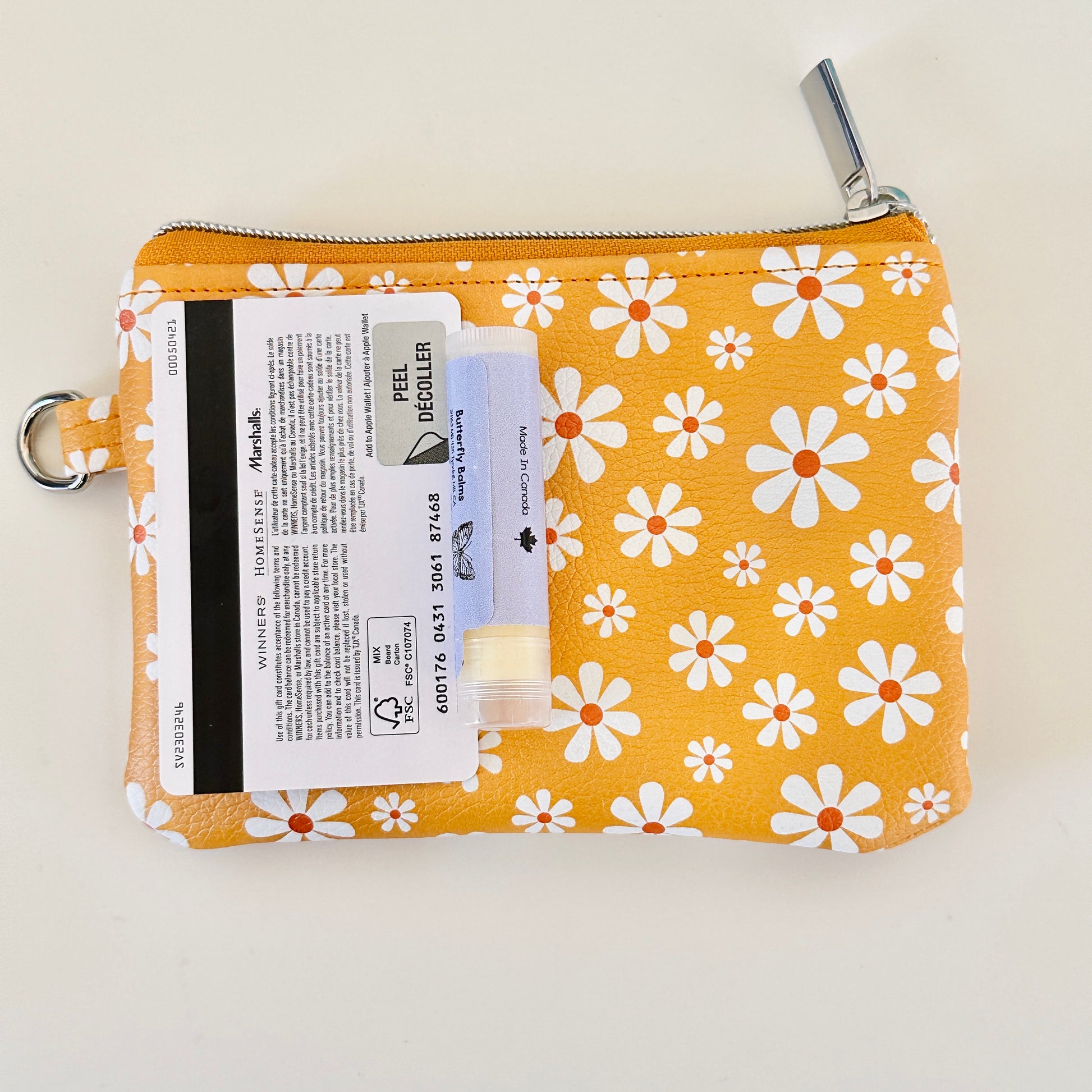 mustard Yellow coin purse with white floral pattern on a white background