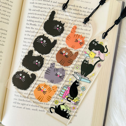 Cat-themed bookmarks on an open book