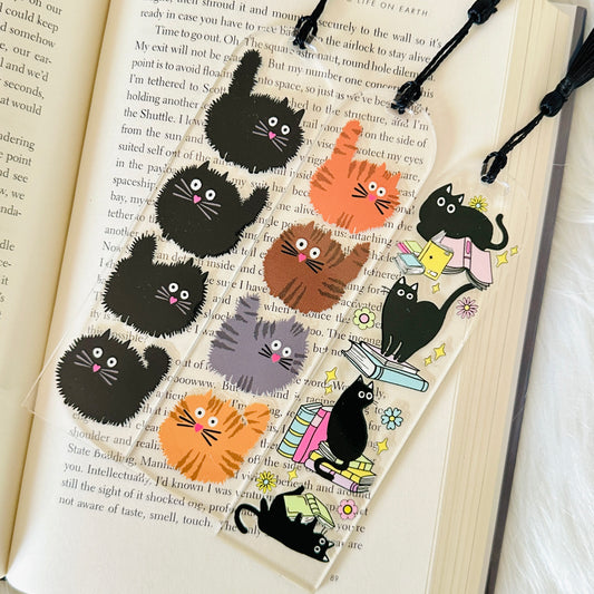 Cat-themed bookmarks on an open book