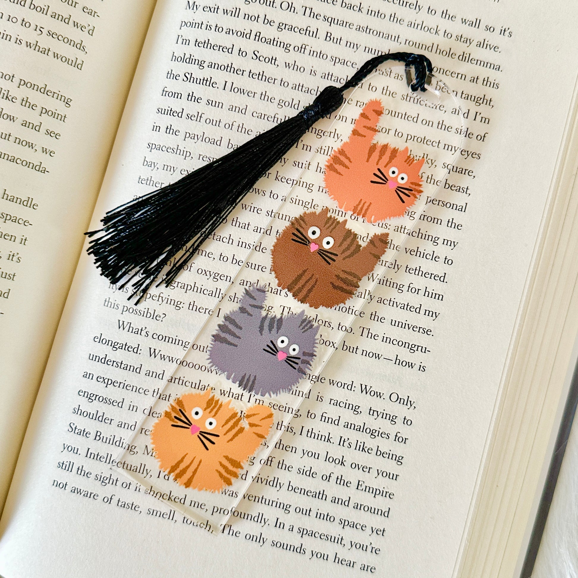 Cat-themed bookmarks on an open book