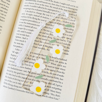 Book with a decorative bookmark featuring yellow dots and green leaves