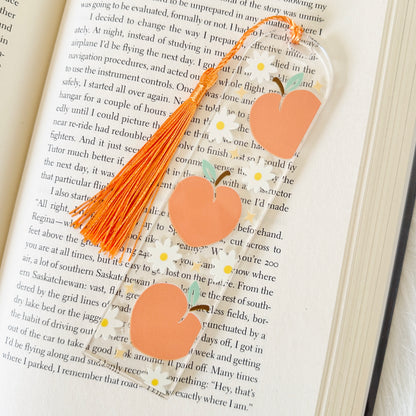 peach bookmark with a tassel on an open book