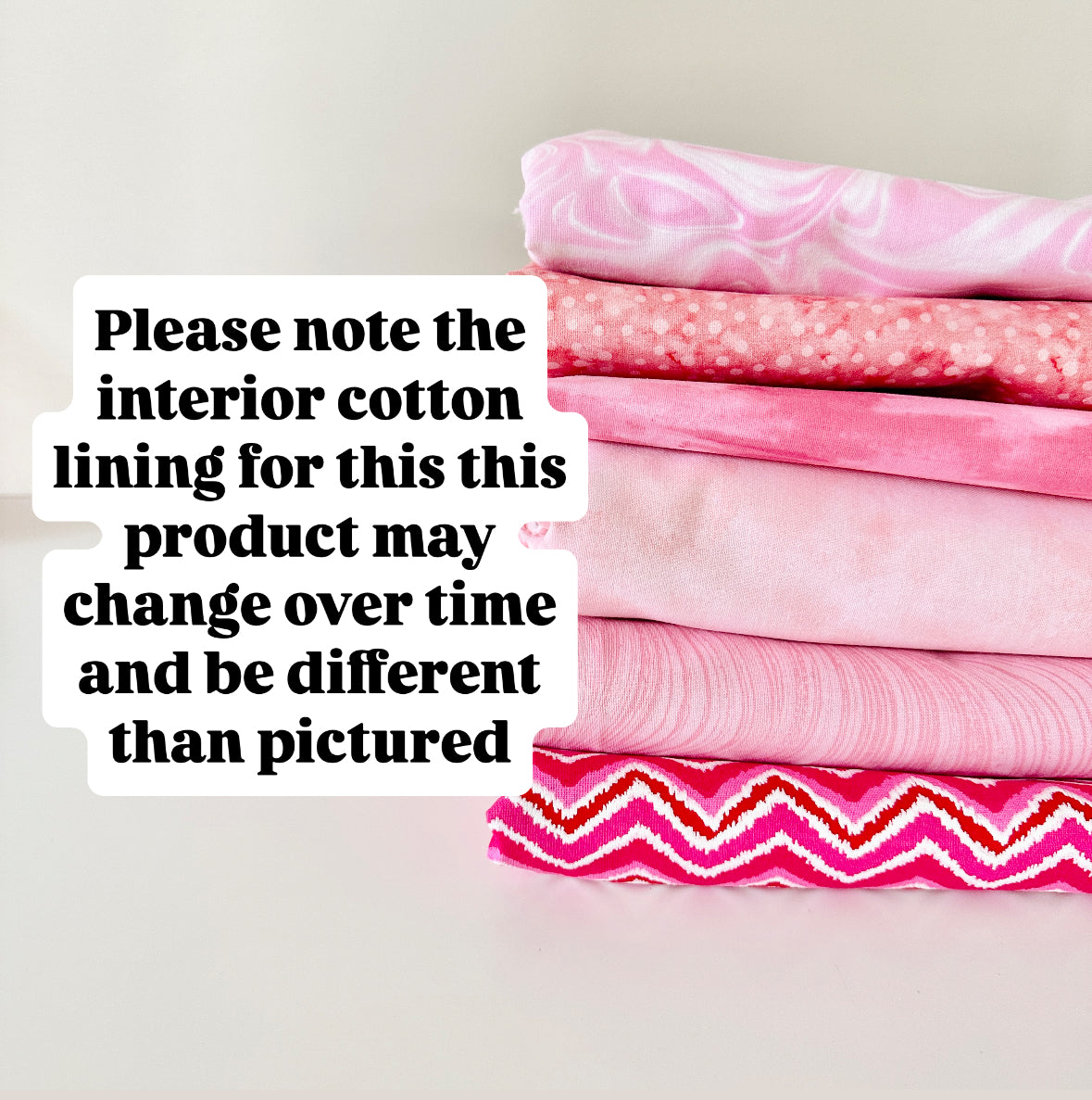 Stack of pink fabric with text overlay on a light background