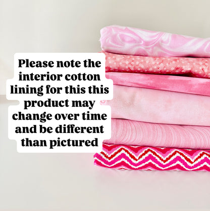 Stack of pink fabric with text overlay on a light background