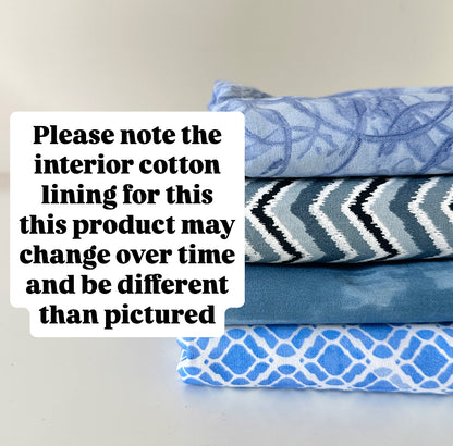 Stack of folded fabric with blue patterns on a light gray background, text overlay about interior cotton lining.