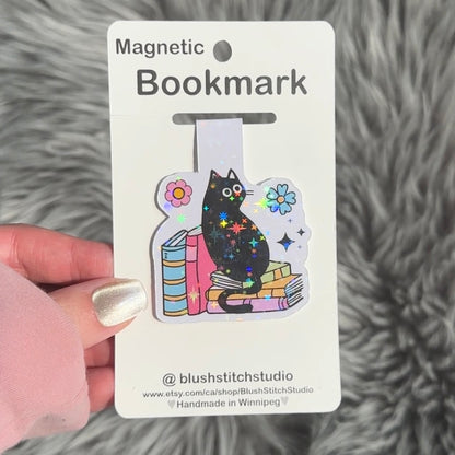 Magnetic bookmark with a black cat design on a gray textured background