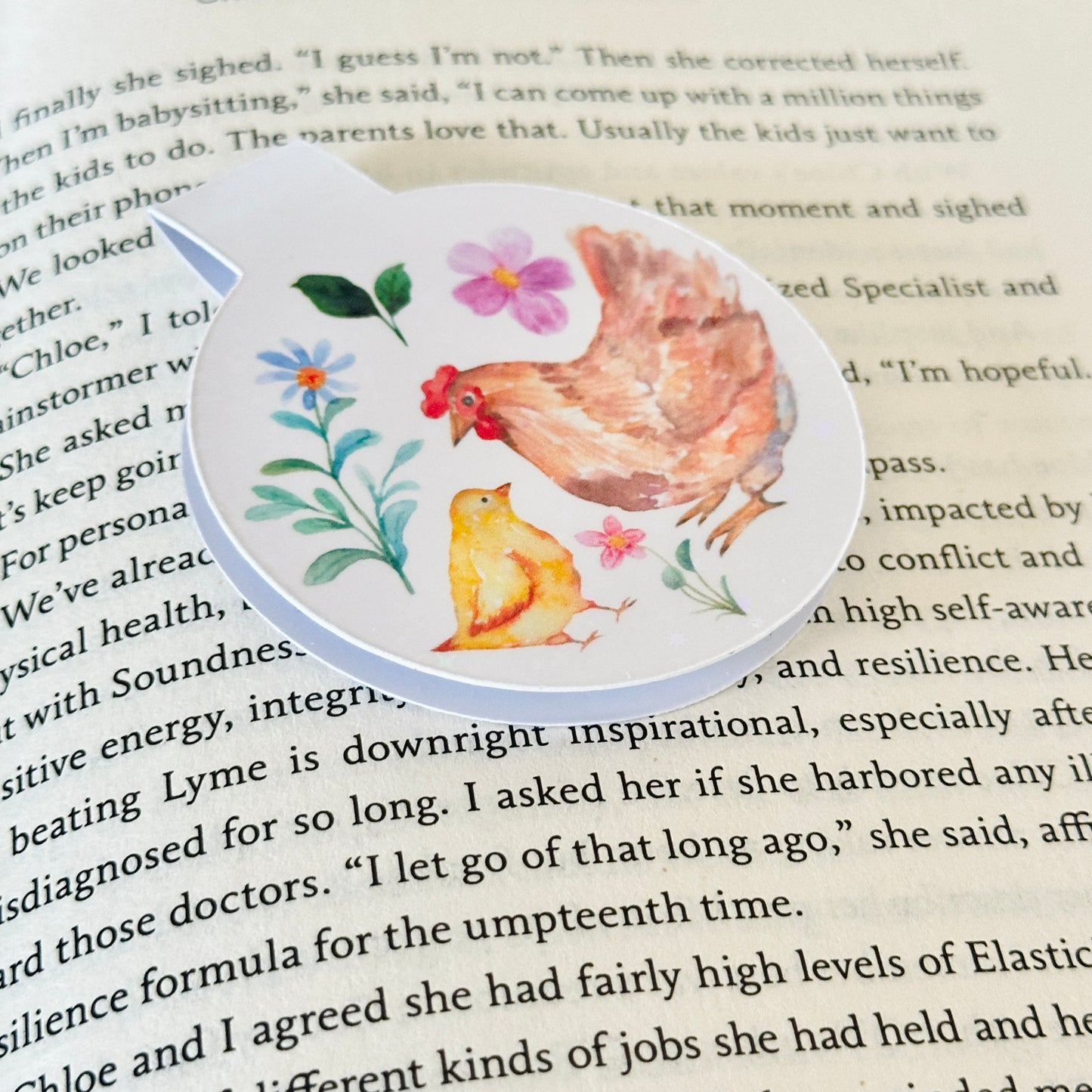 Magnetic bookmark with chicken design on a an open book