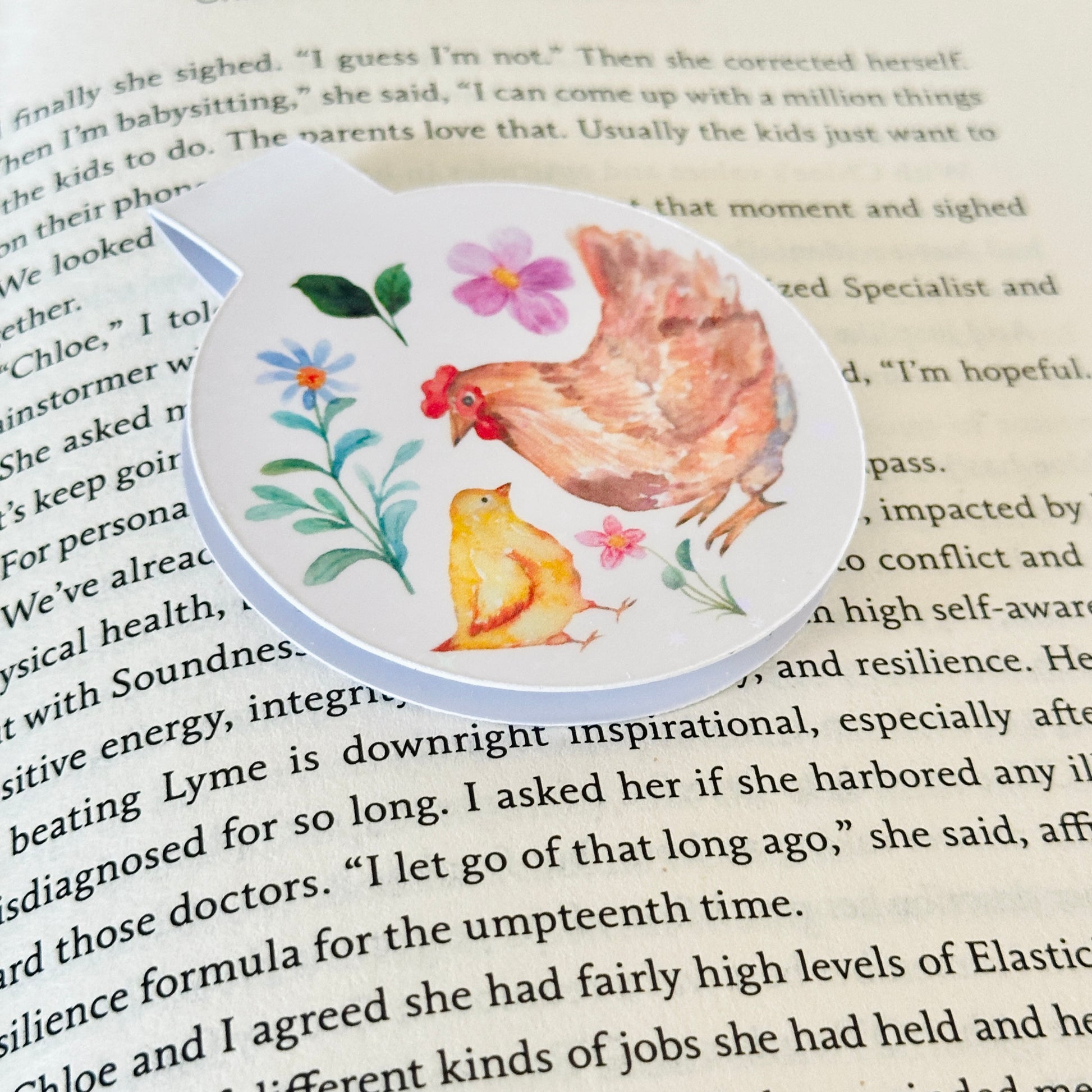 Magnetic bookmark with chicken design on a an open book